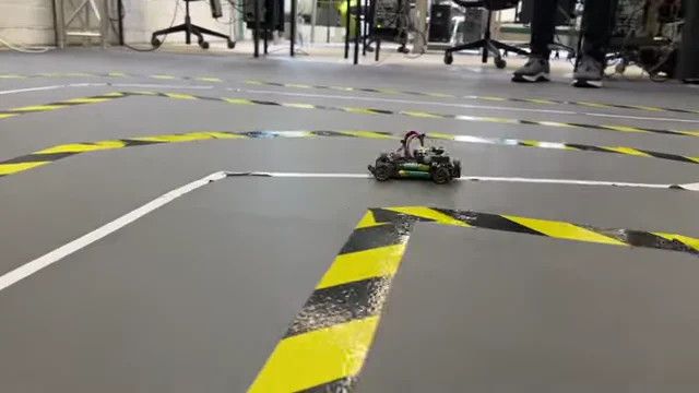 The 1/8-scale Ackermann car driving the taped track in the lab